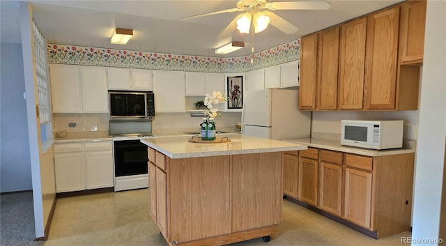 kitchen with ceiling fan, white appliances, a center island, and white cabinets