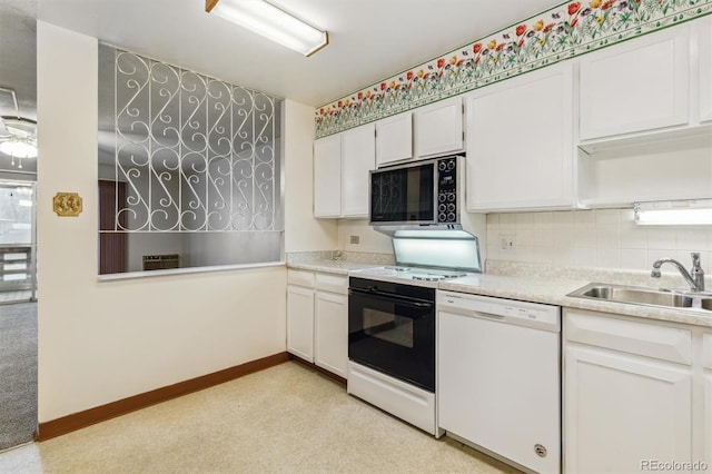 kitchen featuring sink, white cabinetry, white dishwasher, stove, and backsplash