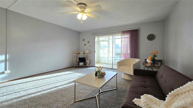 living room with ceiling fan and carpet