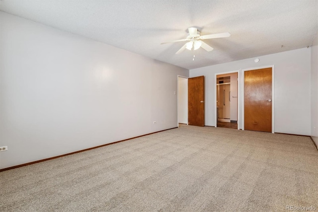 unfurnished bedroom featuring ceiling fan, a textured ceiling, and carpet flooring