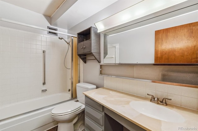 full bathroom with tiled shower / bath combo, vanity, toilet, and decorative backsplash