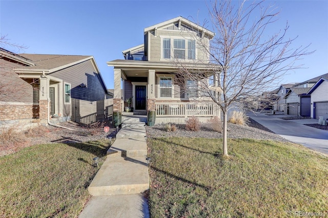 craftsman-style home with covered porch and a front yard