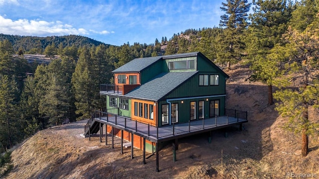 back of property featuring a wooden deck