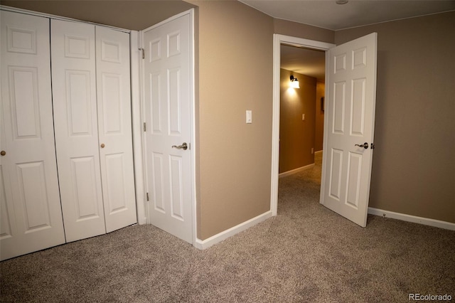 unfurnished bedroom with a closet and carpet