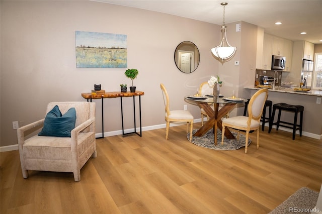 dining area with light hardwood / wood-style flooring