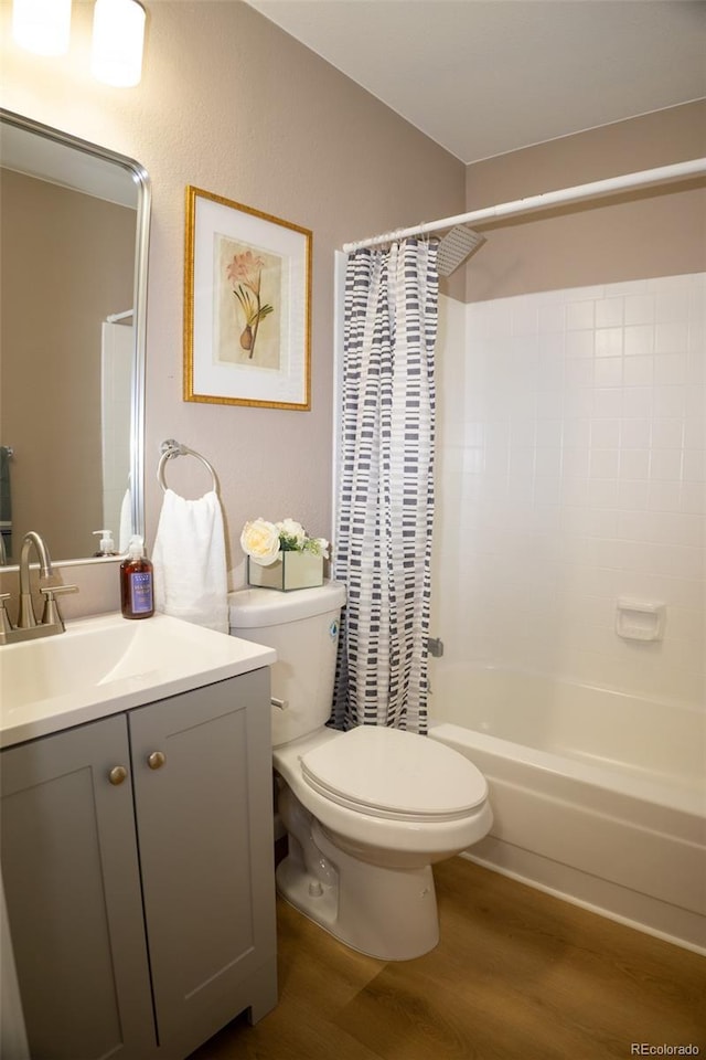 full bathroom with shower / bathtub combination with curtain, vanity, toilet, and hardwood / wood-style floors