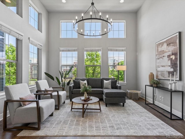 5399 Valentia St, Denver, CO 80238 - living area featuring a chandelier, plenty of natural light, a towering ceiling, wood finished floors, and recessed lighting