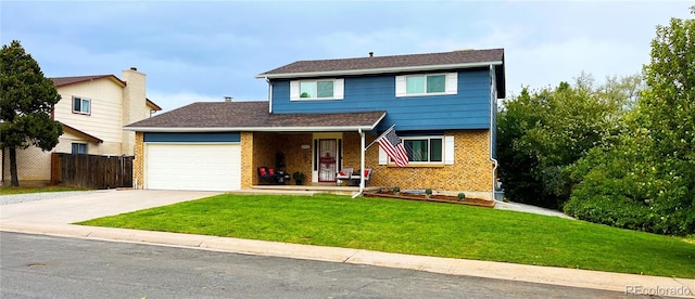 view of front of home featuring a garage and a front yard