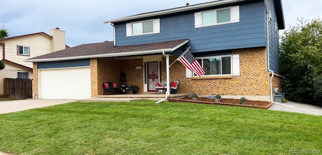 view of property with a front yard, a garage, and covered porch