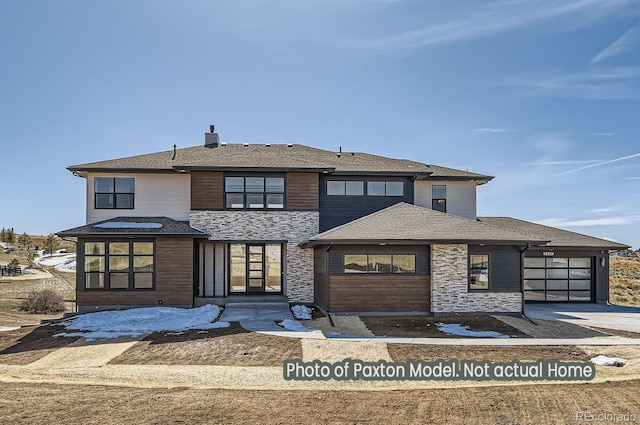 prairie-style home with a garage, concrete driveway, and a shingled roof