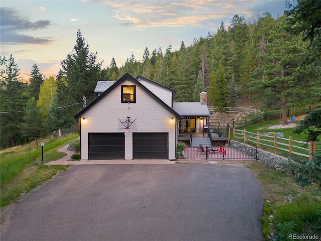 view of front of house with a garage and a lawn