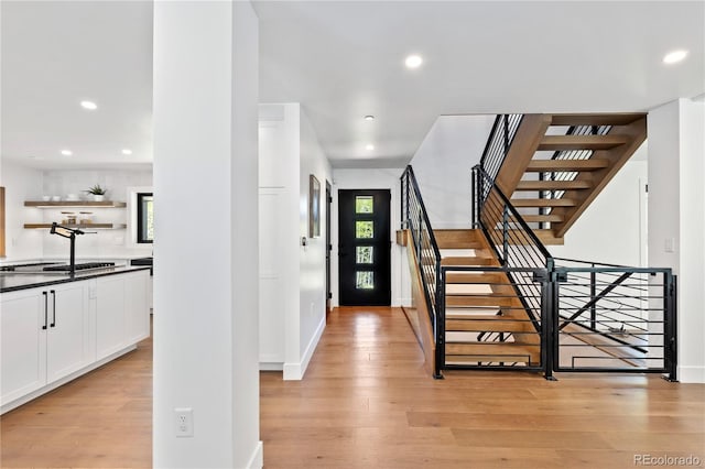 foyer entrance featuring light hardwood / wood-style floors and a healthy amount of sunlight