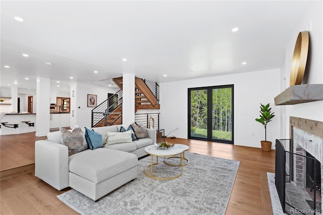 living room featuring french doors and light hardwood / wood-style flooring