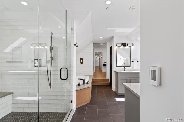 bathroom featuring tile patterned flooring, vanity, and shower with separate bathtub