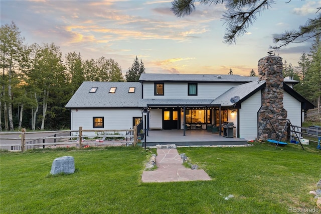 back house at dusk with a yard