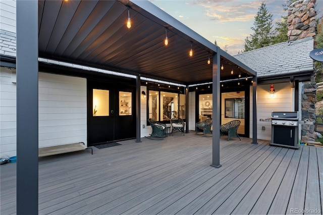 deck at dusk with grilling area