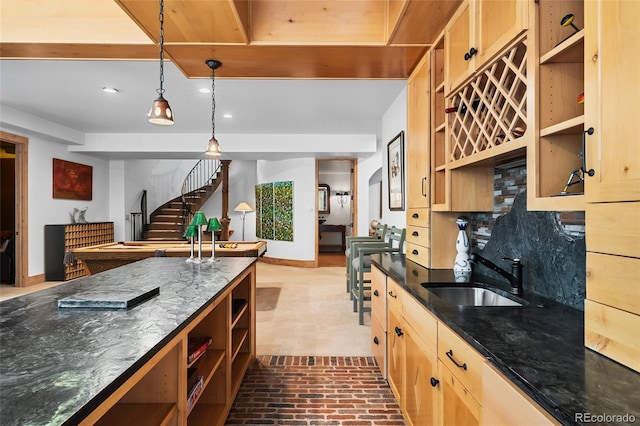 10231 Democrat Rd, Parker, CO 80134 - kitchen with open shelves, recessed lighting, light brown cabinetry, brick patterned floors, and dark stone countertops