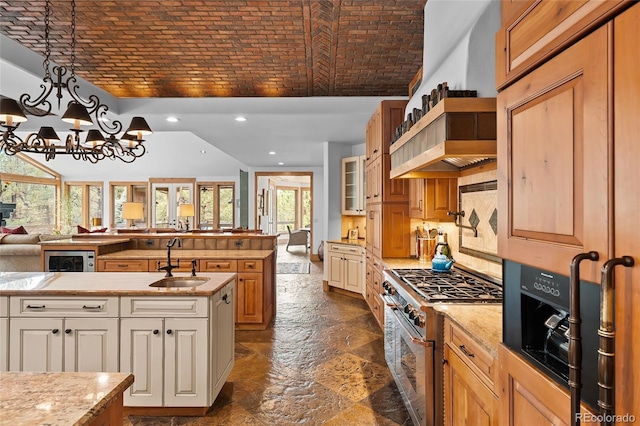 10231 Democrat Rd, Parker, CO 80134 - kitchen featuring high end stainless steel range oven, brick ceiling, open floor plan, lofted ceiling, and glass insert cabinets