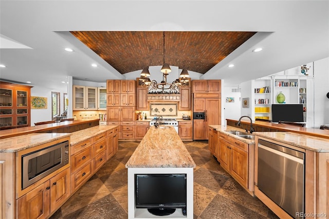 10231 Democrat Rd, Parker, CO 80134 - kitchen with a spacious island, built in appliances, lofted ceiling, a chandelier, and recessed lighting