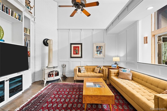 10231 Democrat Rd, Parker, CO 80134 - living room with a decorative wall, a wood stove, and a ceiling fan