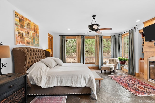 10231 Democrat Rd, Parker, CO 80134 - bedroom featuring finished concrete flooring, multiple windows, a glass covered fireplace, recessed lighting, and ceiling fan