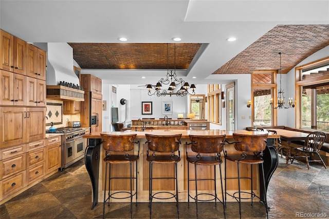 10231 Democrat Rd, Parker, CO 80134 - kitchen with a chandelier, double oven range, custom exhaust hood, a large island with sink, and recessed lighting