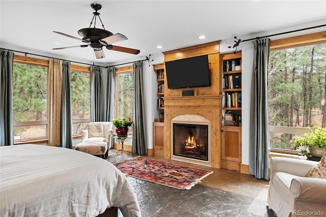10231 Democrat Rd, Parker, CO 80134 - bedroom featuring multiple windows, a glass covered fireplace, and recessed lighting