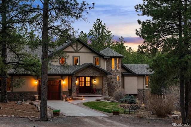 10231 Democrat Rd, Parker, CO 80134 - view of front facade with stone siding, stucco siding, driveway, and an attached garage