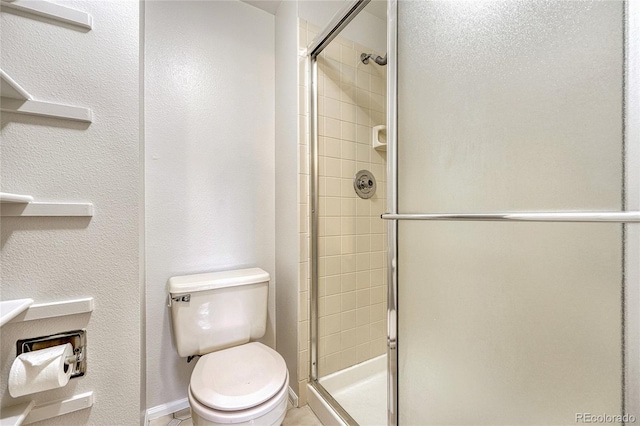 bathroom with tile patterned flooring, an enclosed shower, and toilet