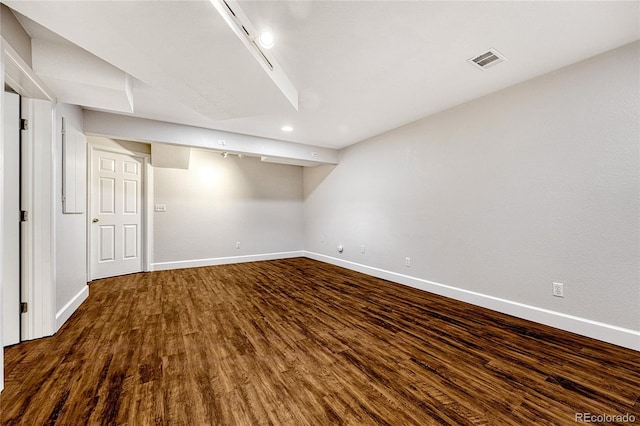 basement featuring dark hardwood / wood-style flooring