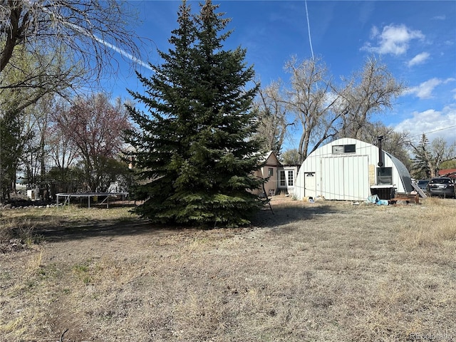 1114 La Due Ave, Alamosa, CO 81101 - view of yard featuring an outdoor structure and a trampoline