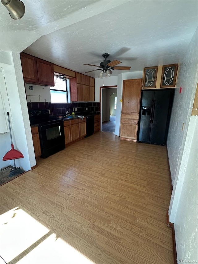 1114 La Due Ave, Alamosa, CO 81101 - kitchen featuring dark countertops, black appliances, a ceiling fan, and light wood-style floors