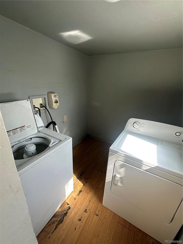 1114 La Due Ave, Alamosa, CO 81101 - washroom with baseboards, laundry area, washer and dryer, and wood finished floors