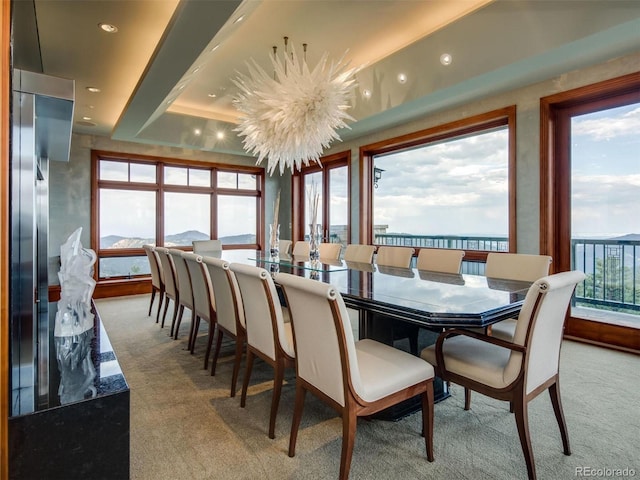 dining area with a notable chandelier and light colored carpet