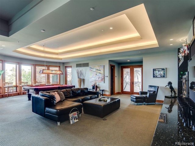 living room with pool table, carpet floors, a raised ceiling, and french doors