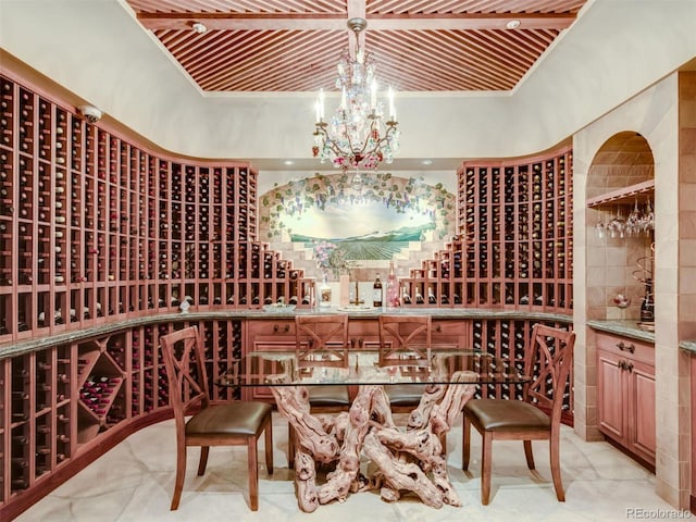 wine area featuring an inviting chandelier