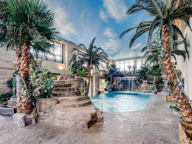 view of pool with a patio and pool water feature