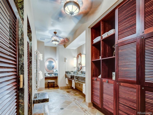 bathroom with ceiling fan and tile patterned floors