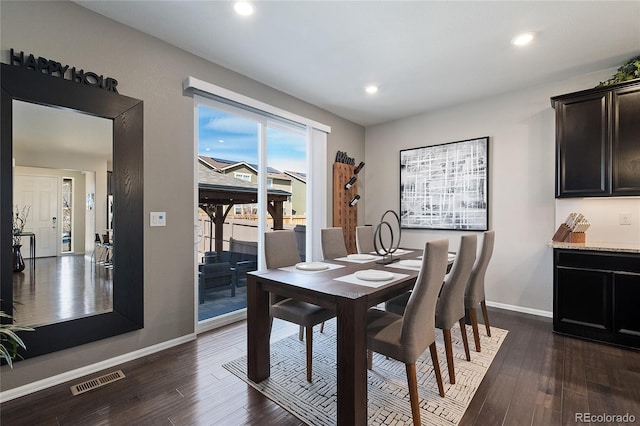 dining area featuring dark wood finished floors, recessed lighting, visible vents, and baseboards