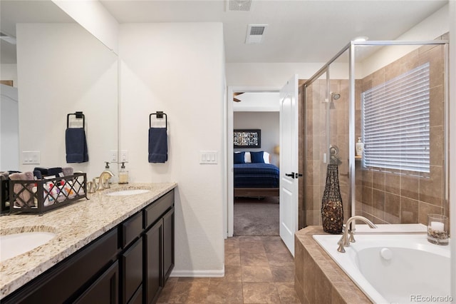 ensuite bathroom featuring visible vents, double vanity, a stall shower, ensuite bath, and a sink