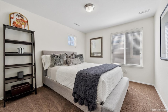 bedroom with baseboards, visible vents, and carpet floors