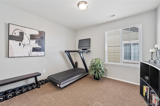 exercise area featuring visible vents, baseboards, and carpet floors