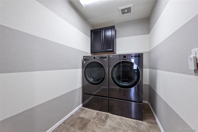 laundry room with visible vents, cabinet space, baseboards, and separate washer and dryer