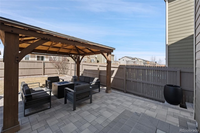 view of patio / terrace with a gazebo, a fire pit, and a fenced backyard