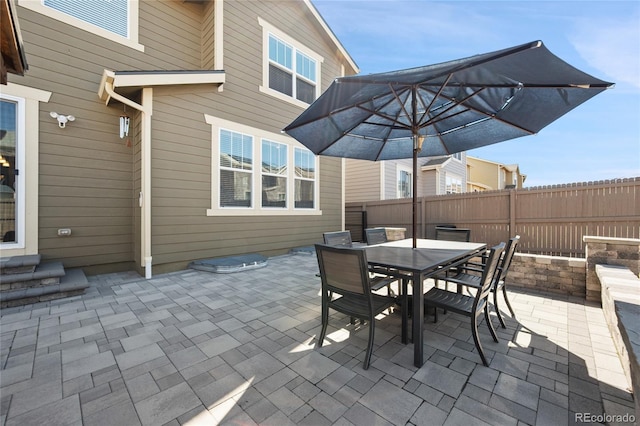 view of patio / terrace featuring outdoor dining area and fence