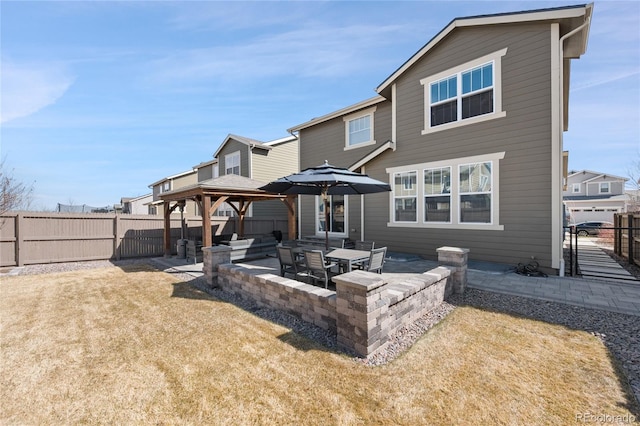 rear view of property with a patio area, a fenced backyard, and a gazebo