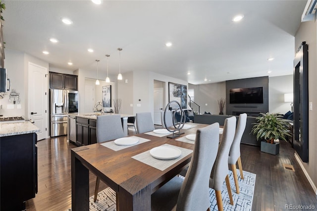 dining room with recessed lighting and dark wood finished floors
