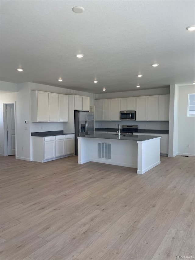 6657 E 149th Dr, Thornton, CO 80602 - kitchen with stainless steel appliances, dark countertops, recessed lighting, baseboards, and light wood-style floors