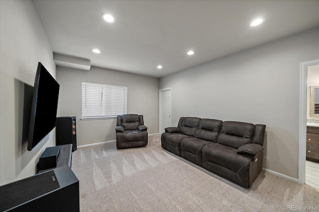 carpeted living area featuring recessed lighting and baseboards