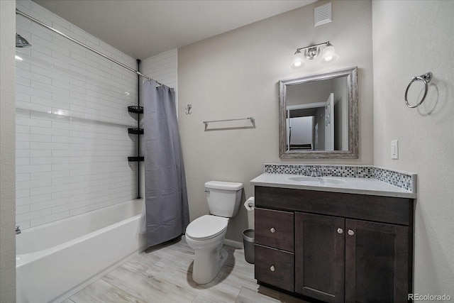 full bathroom with visible vents, toilet, wood finished floors, shower / bath combination with curtain, and vanity